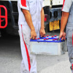 Mechanic,Is,Lifting,The,Truck,Battery.